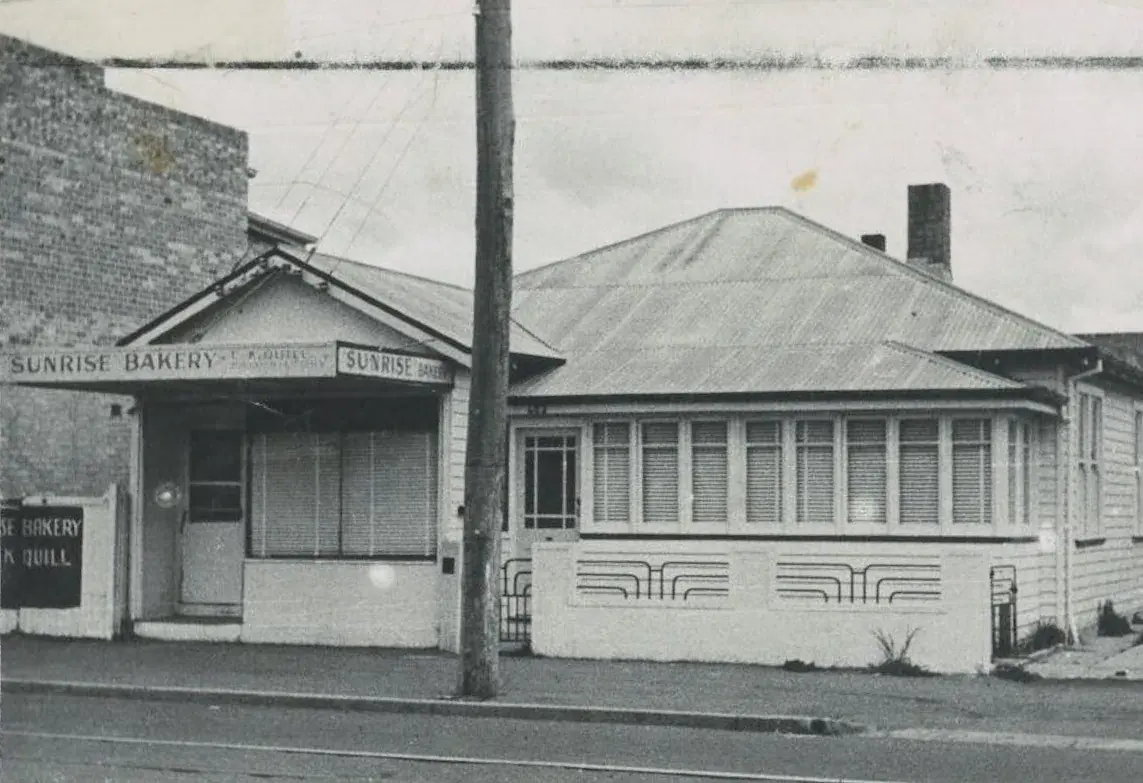 Vintage Sunrise Bakery building exterior, black and white photo.